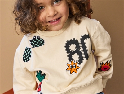 THE NEW siblings sweatshirt gardenia with fun embroidered figures